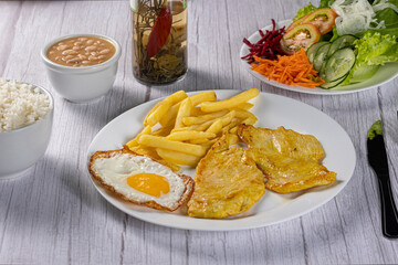 grilled chicken with eggs, fries and vegetables