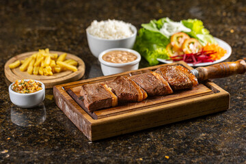 steak with fries, rice, beans and salad