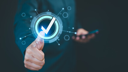 Close-up of a hand showing a thumbs-up with a digital checkmark symbol, representing approval and success. The futuristic overlay and graphics suggest technology, validation, and positive feedback.