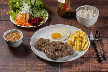 grilled steak with fries, rice and egg