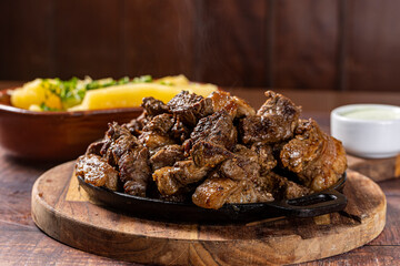 pieces of grilled meat with cassava