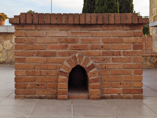 Rectangular rustic Mediterranean brick barbecue front with red terracotta bricks and built-in...