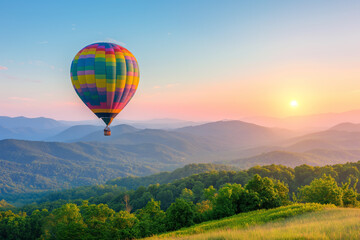 Naklejka premium A colorful hot air ballon floating above the green hills at sunrise, symbolising freedom and adventure in travel and vacation planning.