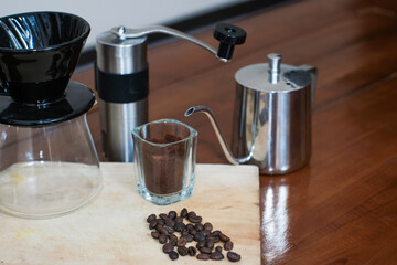 V60 coffee method of making coffee with Complete V60 set tools on the wooden table, making homemade coffee.