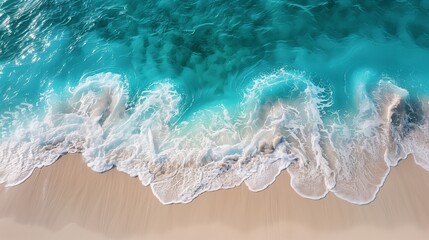 Fototapeta premium A serene beach scene with turquoise waves lapping at the shore, creating patterns of white and beige sand