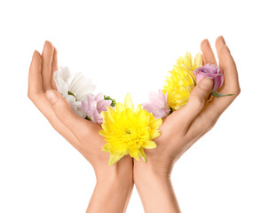 Female hands with beautiful flowers isolated on white background. Hand care concept