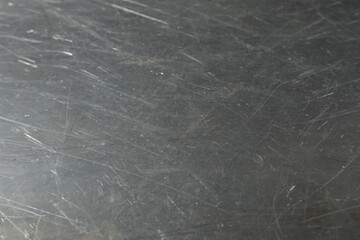 Texture of scratched metallic surface as background, closeup