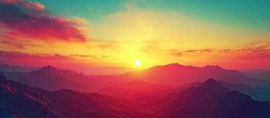 Fototapeta premium Vibrant sunrise over a mountain range with clouds and a golden sky.