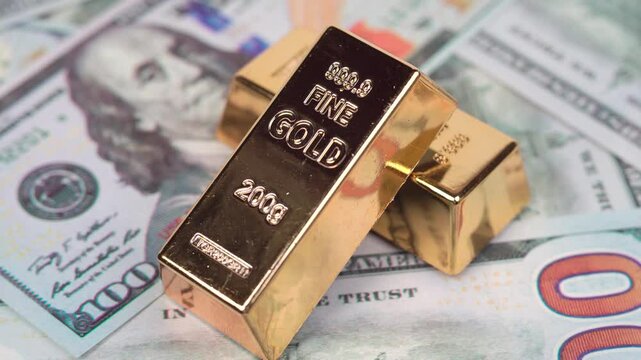 Rotating gold bar and 100-dollar bill on a white background, symbolizing wealth, investment, and financial security