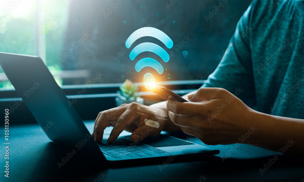 Wall mural hands using mobile phone and laptop with glowing wifi icon and login screen in technology concept. d
