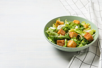 Fried tofu salad in a bowl on a white background