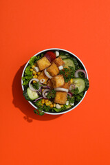 Fried tofu salad in a bowl, top view