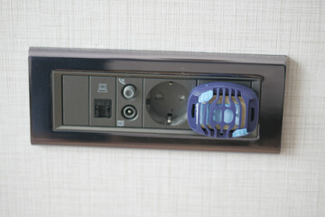 Obraz premium Close-Up of Electric Plug with Insect Repellent Device