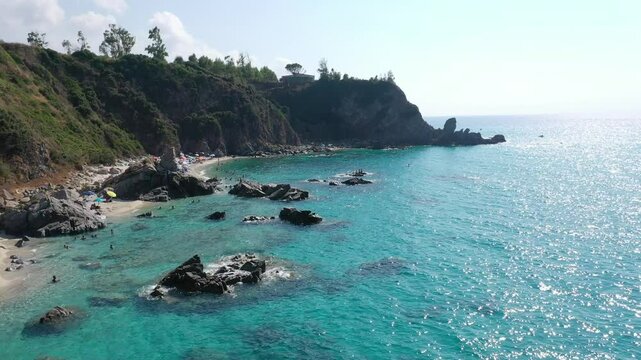 Aerial view of sea and rocky beach in Marinella Di Zambrone on a sunny summer day in Calabria, Italy