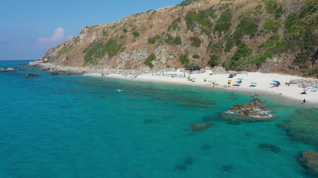 Aerial view of sea and rocky beach in Marinella Di Zambrone on a sunny summer day in Calabria, Italy