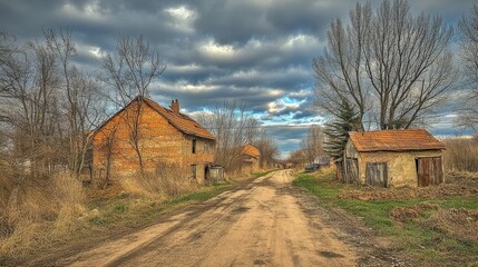 Fototapeta premium Road with a few houses on it and a cloudy sky