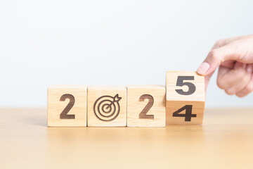 2024 year change to 2025 year block with dartboard icon. Goal, Target, Resolution, strategy, plan,...