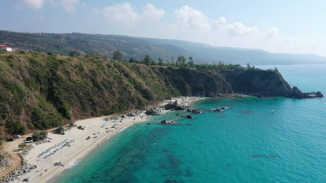 Aerial view of sea and rocky beach in Marinella Di Zambrone on a sunny summer day in Calabria, Italy