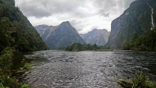 Rainy Day at Sandfly Point: Dramatic Waterfalls Cascading from Lush Cliffs in Fiordland National Park, New Zealand