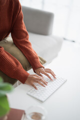 Beautiful asian Woman working by using wireless bluetooth white keyboard computer Hands typing on...