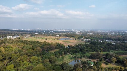 Obraz premium Aerial view of countryside meeting city skyline under cloudy sky in Chiang Mai Thailand