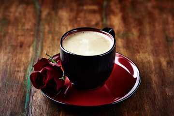 Cup of coffee on wooden background. Close up