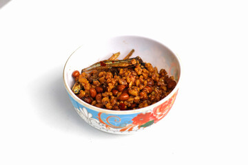 Indonesian dish dried tempeh, made from tempeh or soybeans cut into small pieces, cooked with chili, soy sauce and anchovies, isolated on white background