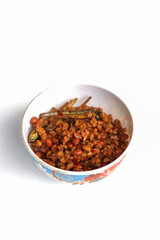 Indonesian dish dried tempeh, made from tempeh or soybeans cut into small pieces, cooked with chili, soy sauce and anchovies, isolated on white background