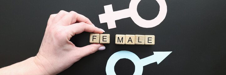 Hand takes away part of world Female between genders symbols