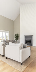 Fototapeta premium Modern living room with cozy furniture and a fireplace in a bright, inviting home setting