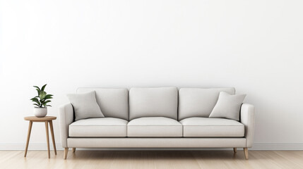 A light gray sofa adorned with soft cushions is positioned against a plain white wall