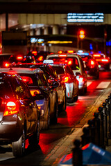 Cars waiting at a red light in a traffic jam.