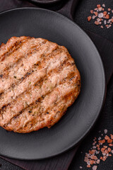 Juicy grilled beef or pork steak with salt, spices and herbs