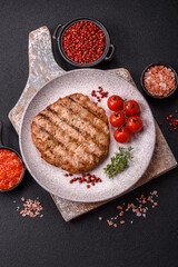 Juicy grilled beef or pork steak with salt, spices and herbs