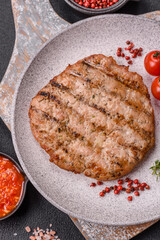 Juicy grilled beef or pork steak with salt, spices and herbs