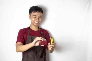 teenage bartender making a banana transaction with his credit card