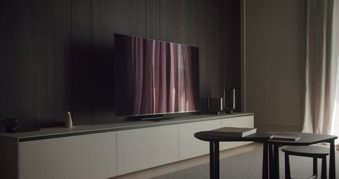 A stylish living room featuring a flat screen TV, sleek modern furniture, and minimalist decor on an entertainment unit. Modern Living Room with Flat Screen TV and Minimalist Decor