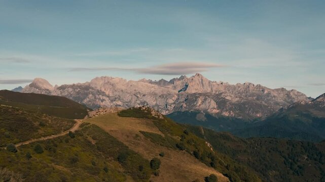 View of Picos de Europa Mountain Range with beautifull full moon light rays during night view from collado de Llesba in Northern Spain, Cantabria.