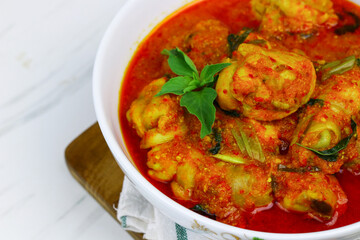 Fototapeta premium Ayam Rica-Rica, traditional Indonesian hot and spicy braised chicken. White marble background, selected focus.