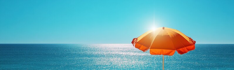 Yellow umbrella sitting on the beach near the ocean