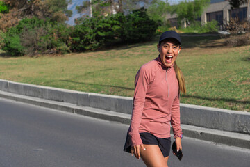 Excited young Latina woman enjoying an outdoor walk on a sunny day