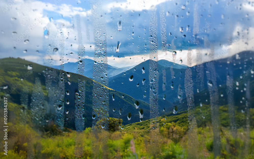 Poster A view of rolling green hills through a window covered in raindrops.