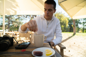 Handsome man in a cafe drinking tea