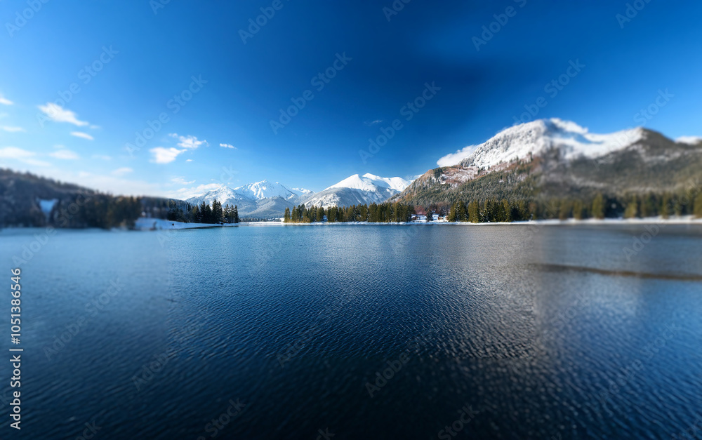 Poster a panoramic view of a serene lake surrounded by snow-capped mountains, with a bright blue sky and a 