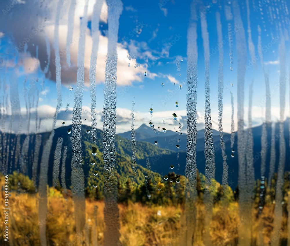 Aufkleber A view of a mountain range through a condensation covered window.