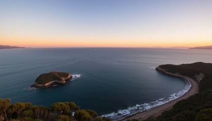 Fototapeta premium Coastal Landscape at Sunset with a Small Island and a Curved Beach