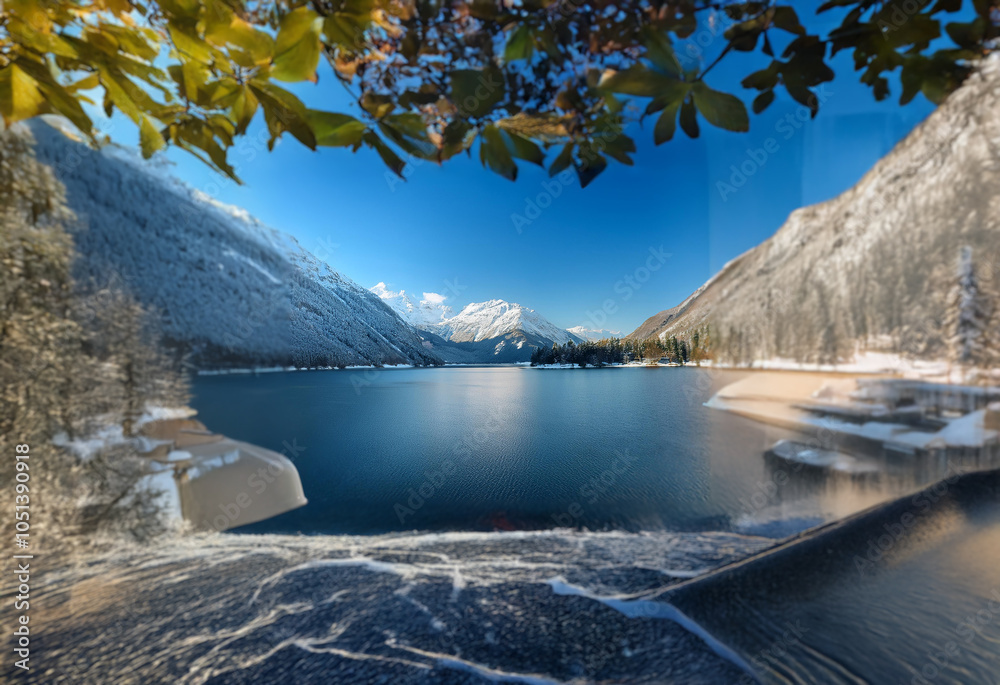 Poster A view of a lake surrounded by snow-capped mountains.  The lake's surface is calm and reflects the blue sky.