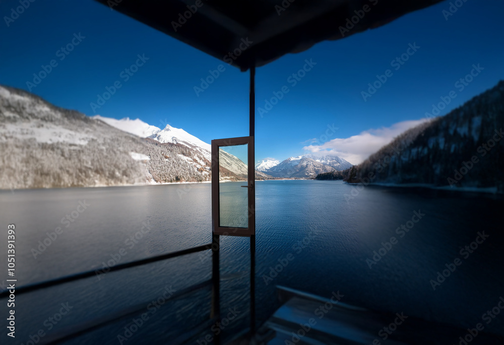 Poster A view through an open door on a deck overlooking a still lake and snow-capped mountains on a clear day.