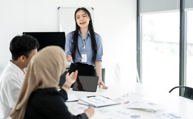 A group of asian business people partners during a set team meeting in the modern office.