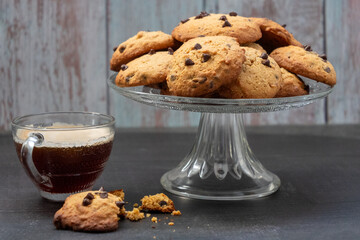 A glass of coffee and a plate of cookies